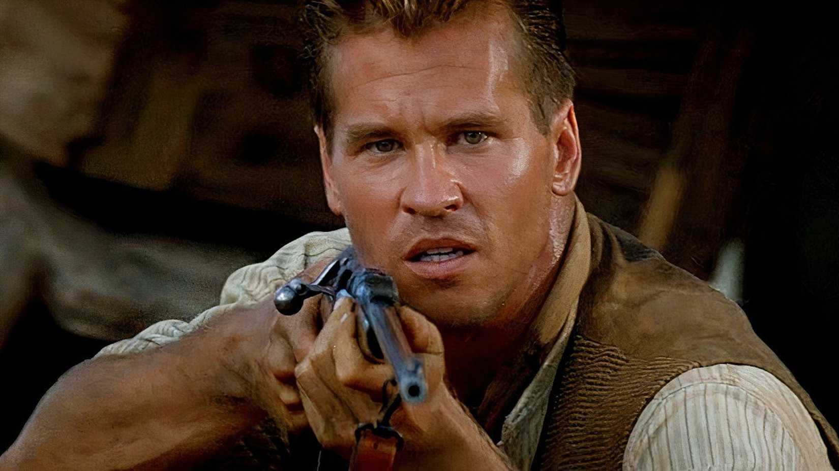 val kilmer as colonel patterson aiming his gun at a lion in The Ghost and the Darkness