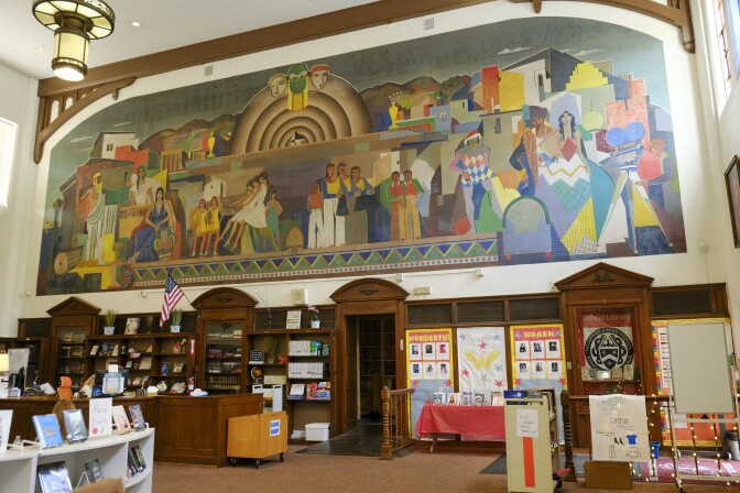 The colorful mural includes dancers, actors and a large bandshell. 