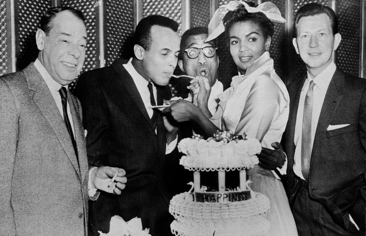 Sammy Davis Jr., 32, and Loray White, 23, cut a cake for their close celebrity friends right after their wedding in Las Vegas on January 11, 1958. From left to right, guests are: Joe E. Lewis; best man, Harry Belafonte; Davis; White and Donald O'Connor.