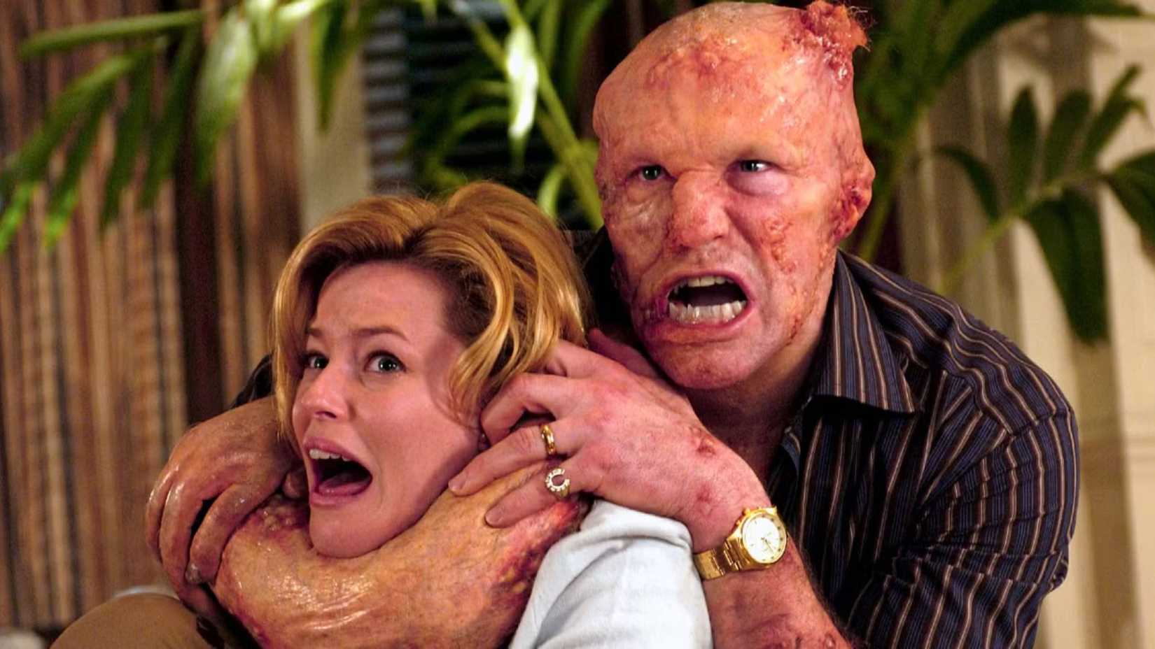 Michael Rooker holds Elizabeth Banks in a chokehold in Slither (2006)