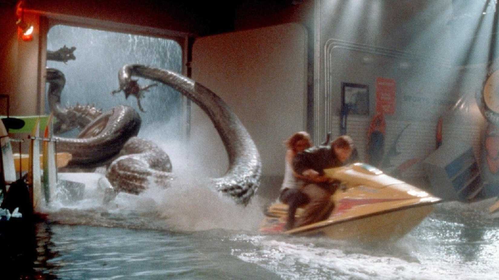 2 people run away from a tentacle monster on a jet ski in Deep Rising