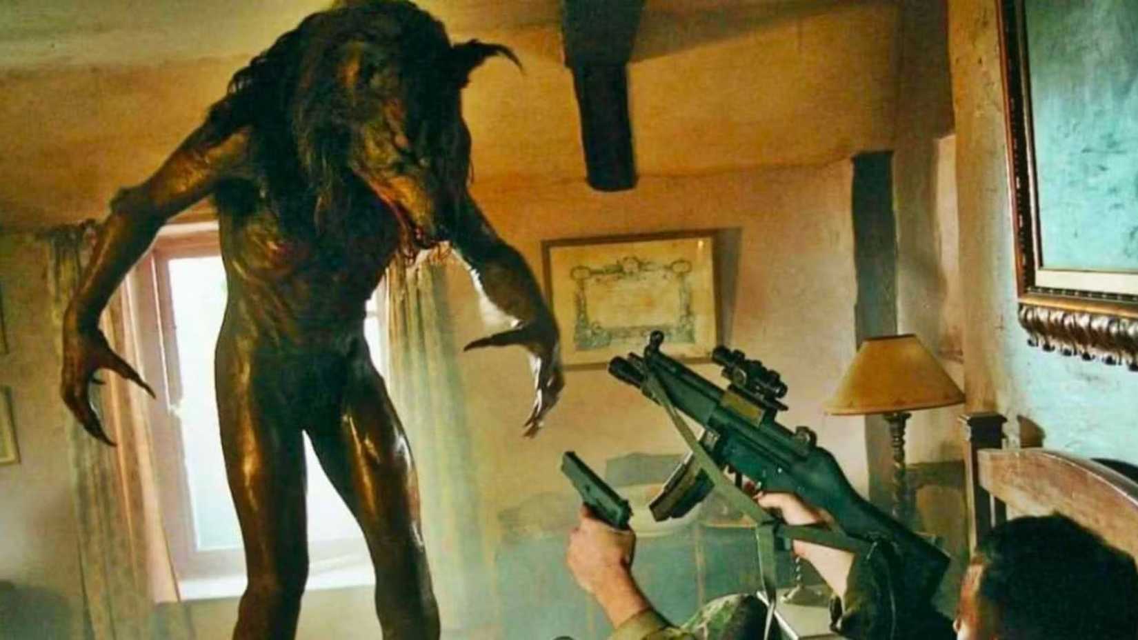 A werewolf attacks a soldier holding 2 guns in Dog Soldiers