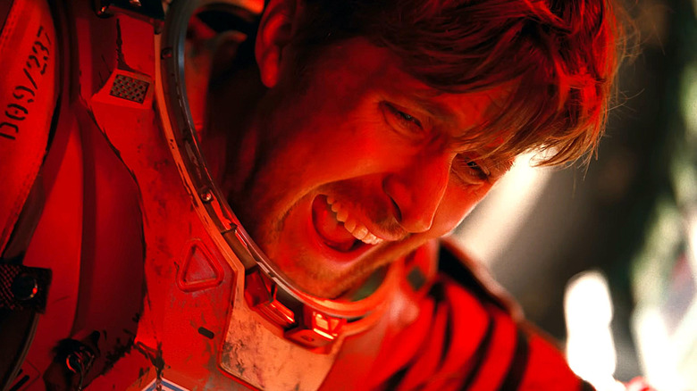 Ryan Gosling as Ryland Grace in an astronaut suit and covered in red light in Project Hail Mary
